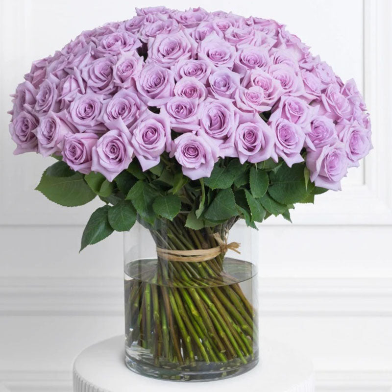 Spring as Lilac Roses Fresh Flower Arrangement on a Glass Vase