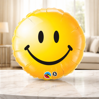 Yellow round foil balloon printed with a smiley face